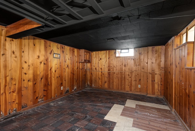 basement featuring wooden walls