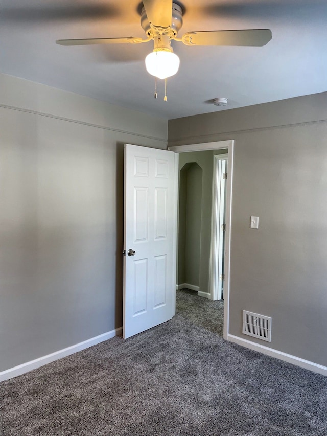 carpeted spare room with ceiling fan