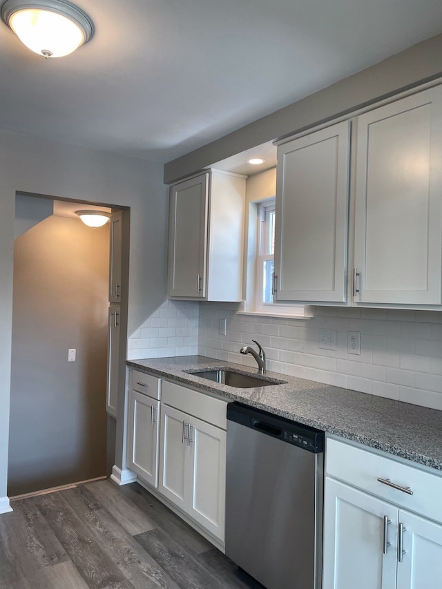 kitchen with white cabinets, decorative backsplash, dishwasher, and sink