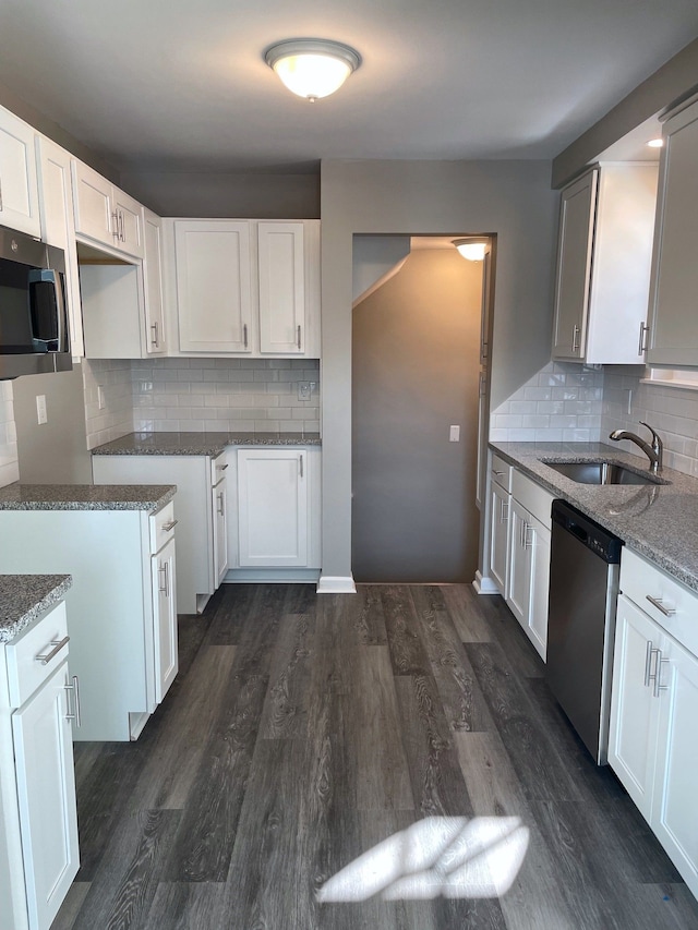 kitchen with white cabinetry, stainless steel appliances, and sink