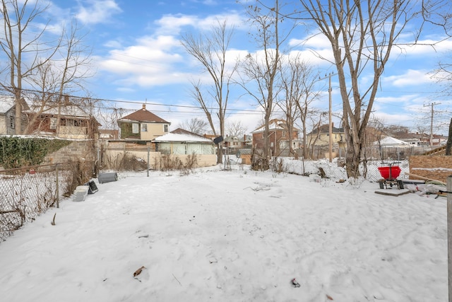 view of yard layered in snow