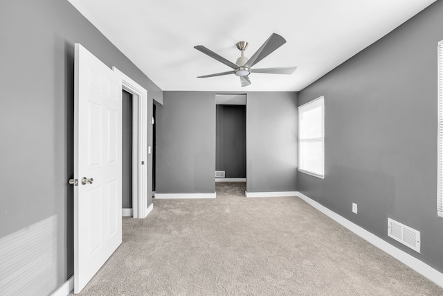 unfurnished bedroom featuring ceiling fan and light carpet