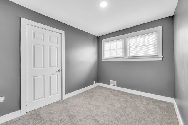 unfurnished room featuring light colored carpet