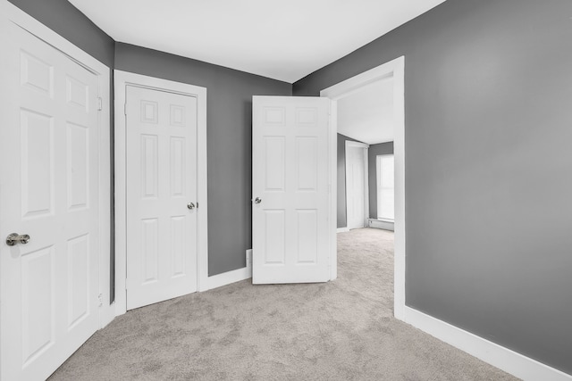 unfurnished bedroom with light carpet