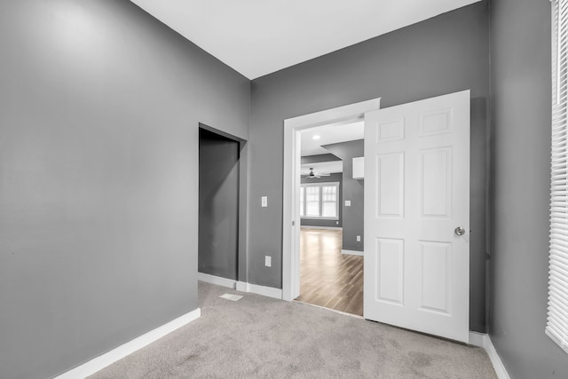 empty room featuring light carpet and ceiling fan