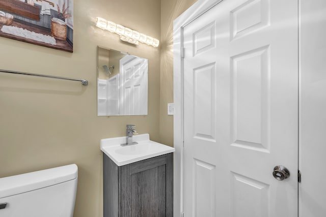 bathroom featuring toilet and vanity