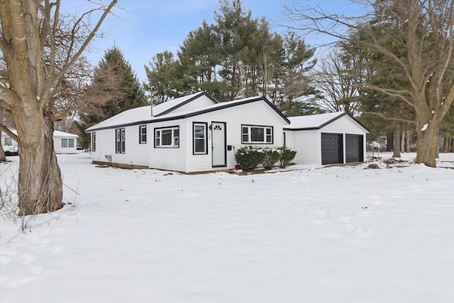 single story home with a garage and an outdoor structure