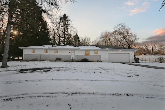 ranch-style home featuring a garage