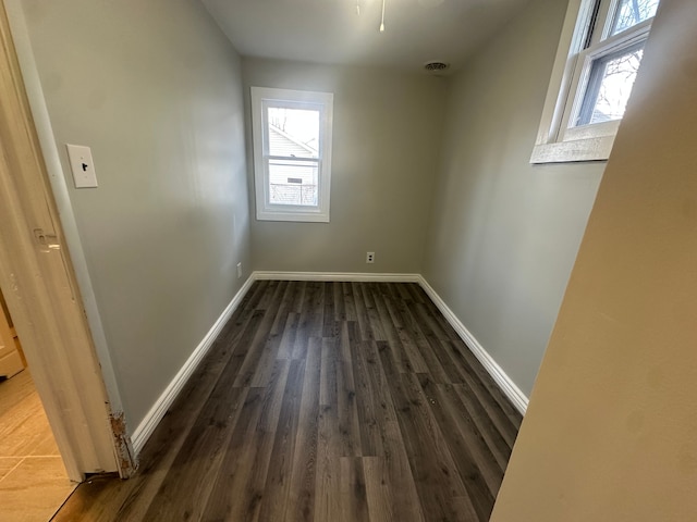 spare room featuring dark wood-type flooring