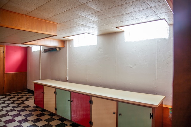 basement featuring wood walls