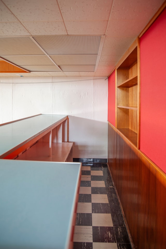 hall featuring wooden walls