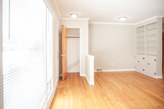 unfurnished bedroom with crown molding and light hardwood / wood-style floors