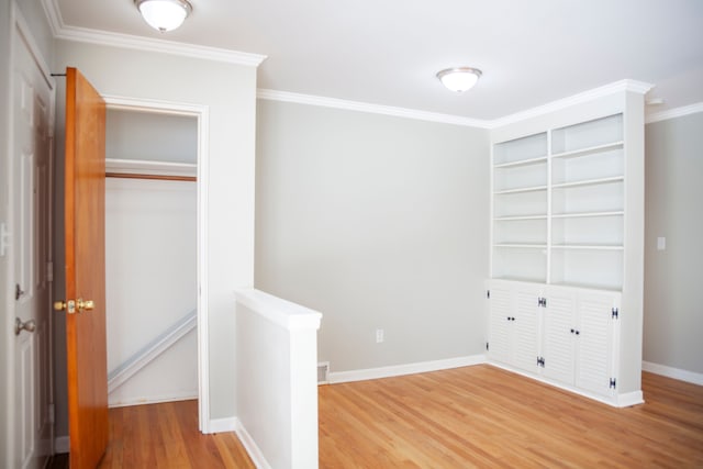 unfurnished bedroom featuring hardwood / wood-style flooring, a closet, and ornamental molding