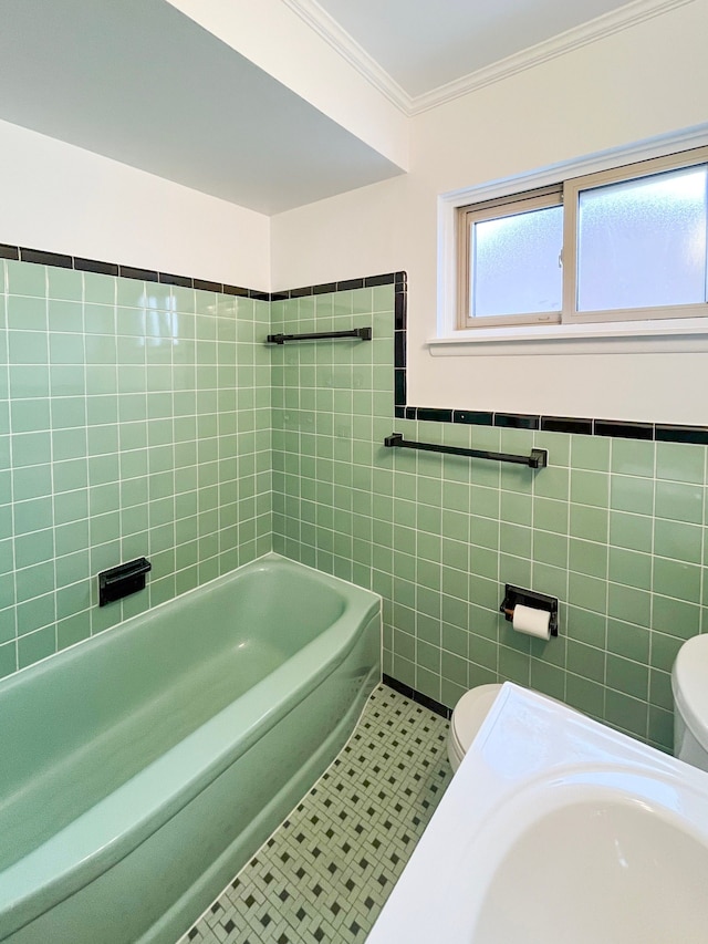 bathroom with tile patterned floors, toilet, tile walls, and crown molding