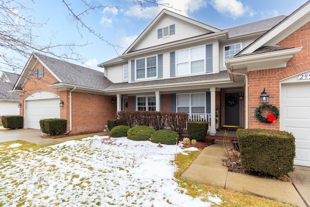 view of front of home with covered porch and a garage