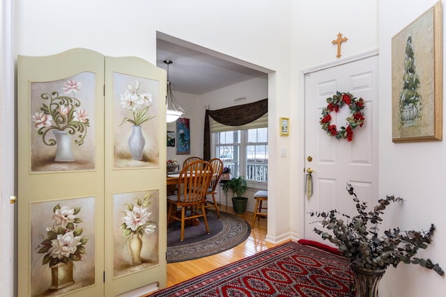 entryway with hardwood / wood-style flooring