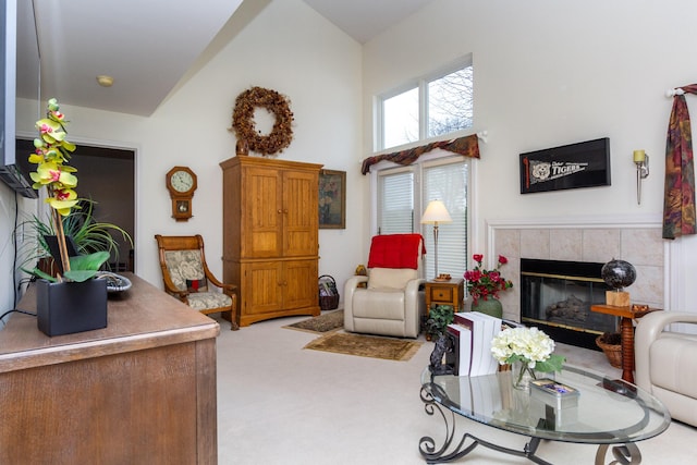 living room with light carpet, a tile fireplace, and a high ceiling