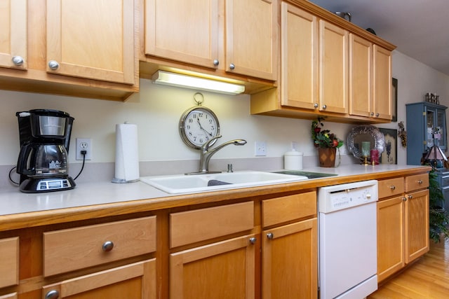 kitchen featuring light wood-type flooring, dishwasher, and sink