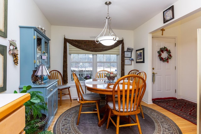 dining space with light hardwood / wood-style flooring