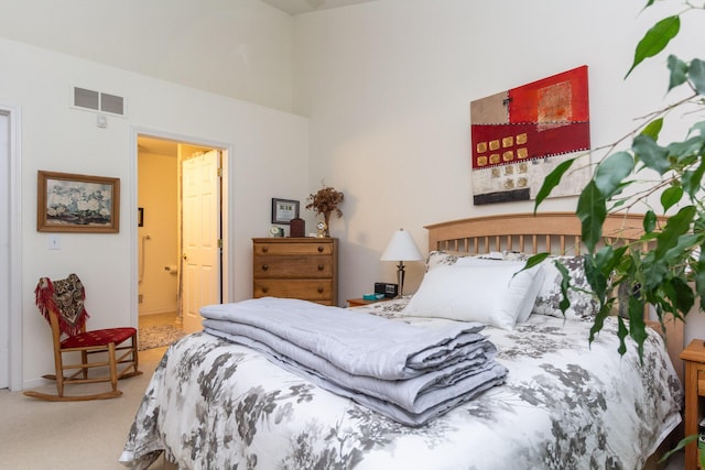 carpeted bedroom with connected bathroom