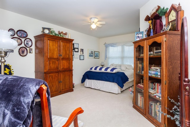 bedroom with ceiling fan and light carpet