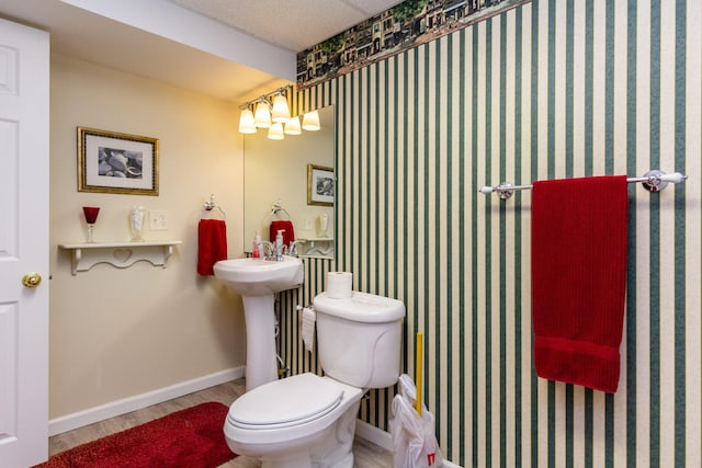 bathroom with toilet and wood-type flooring