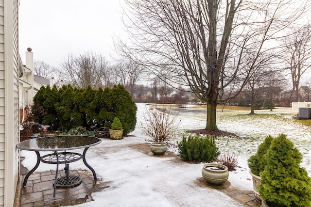 snow covered patio featuring central AC