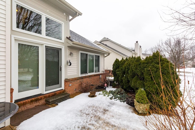 view of snow covered property entrance