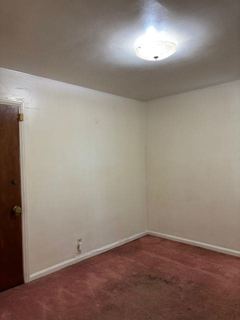 empty room with carpet floors and baseboards