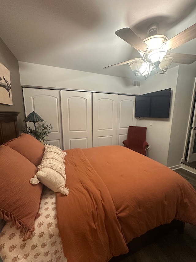 bedroom featuring ceiling fan and a closet