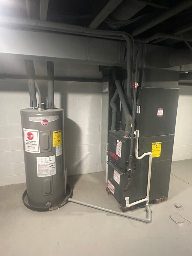 utility room featuring heating unit and electric water heater
