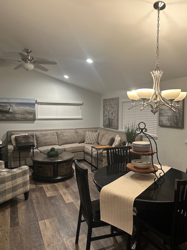 dining space featuring ceiling fan with notable chandelier, vaulted ceiling, wood finished floors, and recessed lighting