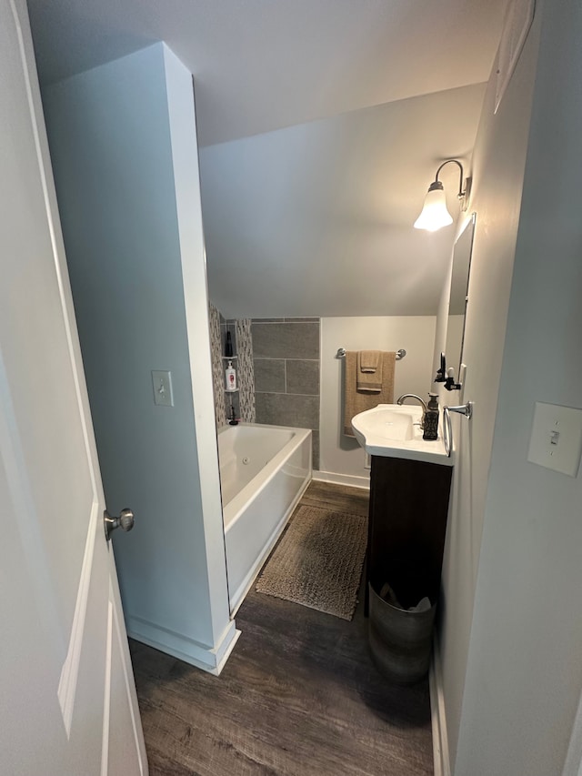 full bathroom featuring baseboards, wood finished floors, and vanity