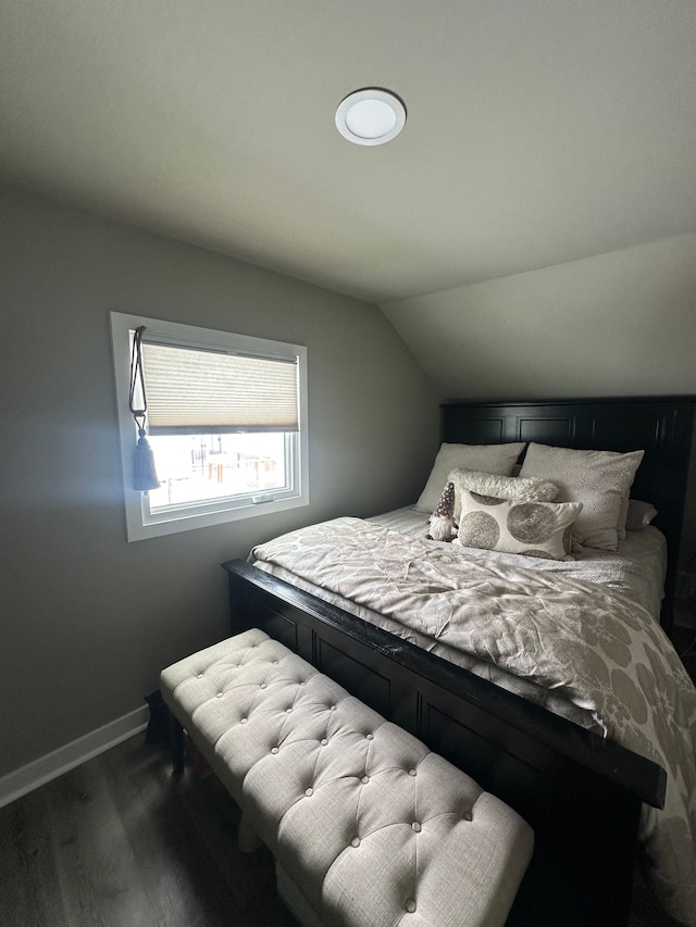 bedroom featuring vaulted ceiling and dark hardwood / wood-style floors