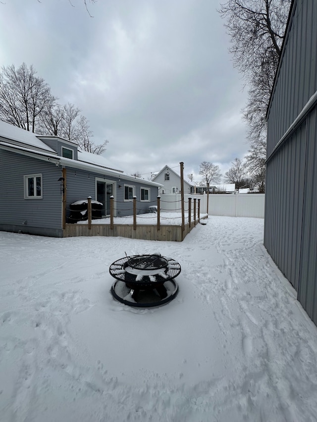 snowy yard featuring a fire pit