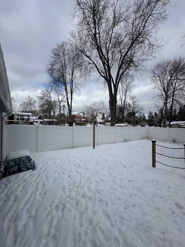 view of yard layered in snow