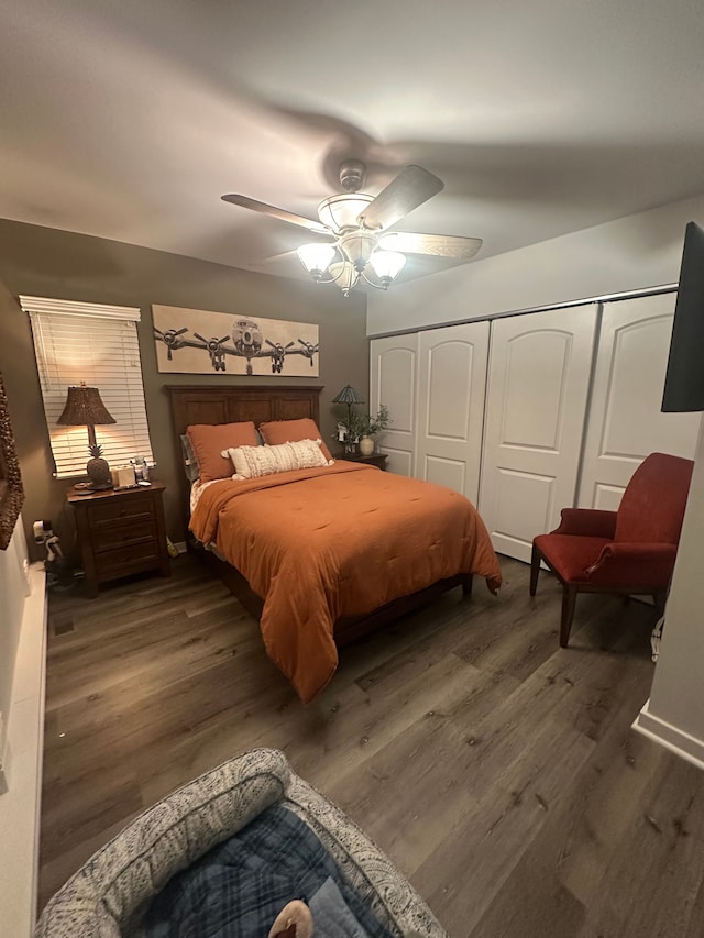 bedroom with a closet, dark hardwood / wood-style floors, and ceiling fan