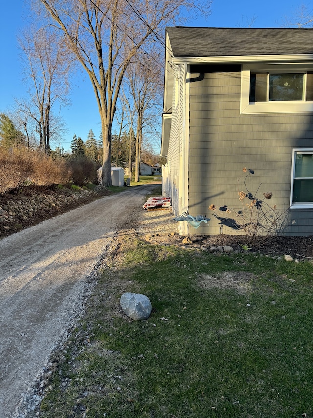 view of home's exterior with driveway and a yard