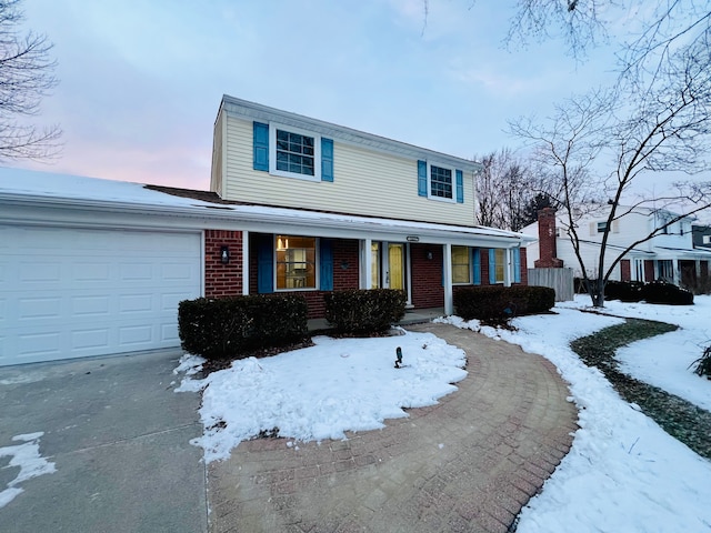 front of property featuring a garage and covered porch