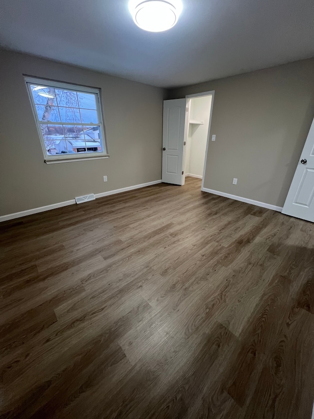 unfurnished bedroom with wood-type flooring