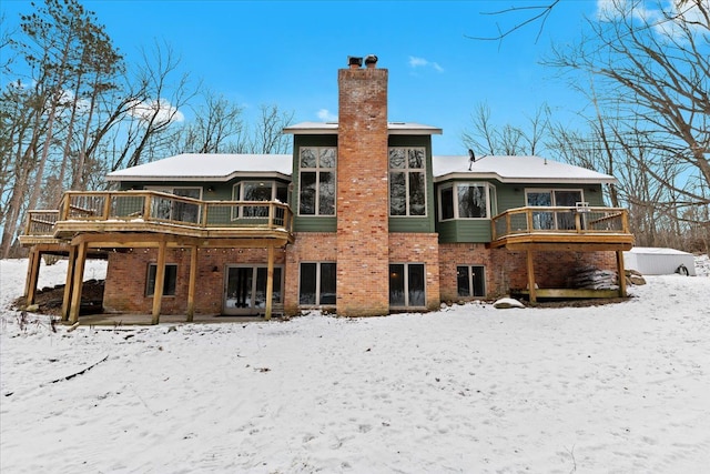 snow covered property featuring a deck