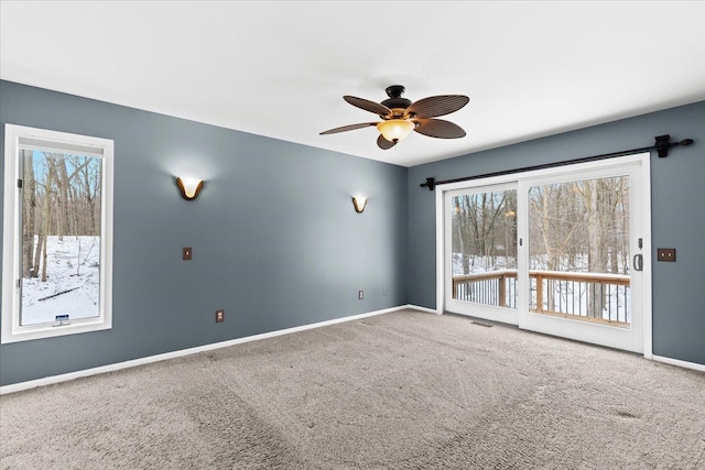 carpeted spare room with ceiling fan