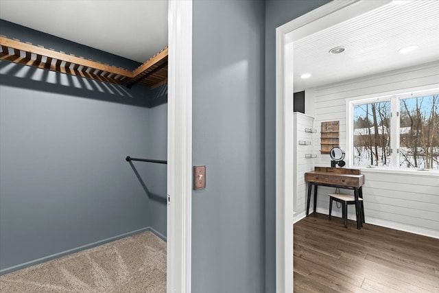 spacious closet with dark hardwood / wood-style flooring