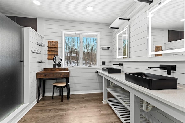 interior space featuring sink, dark wood-type flooring, and wooden walls