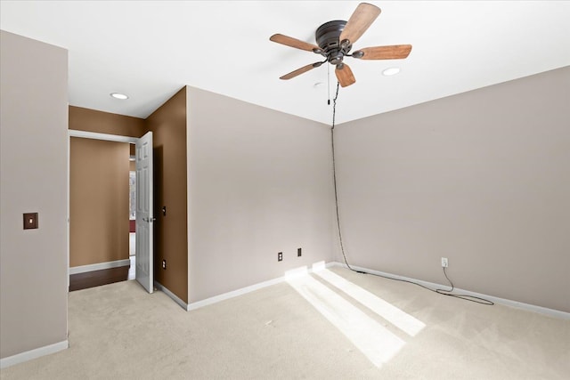 carpeted empty room featuring ceiling fan