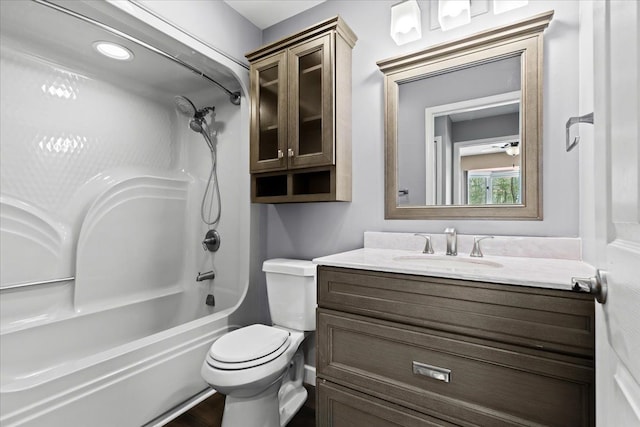 full bathroom featuring vanity, washtub / shower combination, and toilet