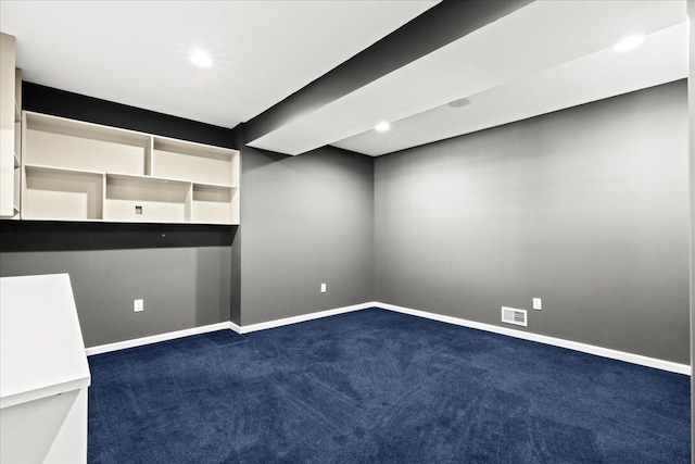 unfurnished room with dark colored carpet