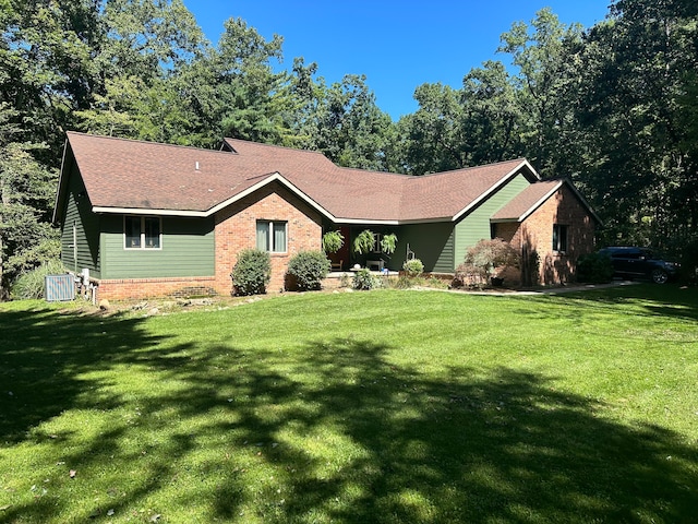 ranch-style house with a front lawn and central air condition unit