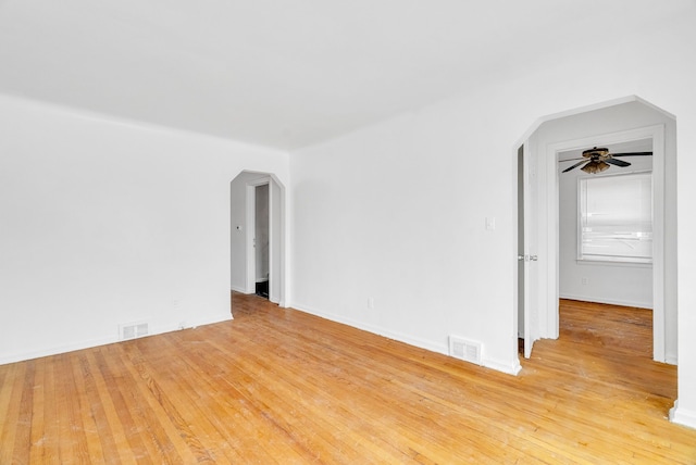 empty room with ceiling fan and light hardwood / wood-style flooring