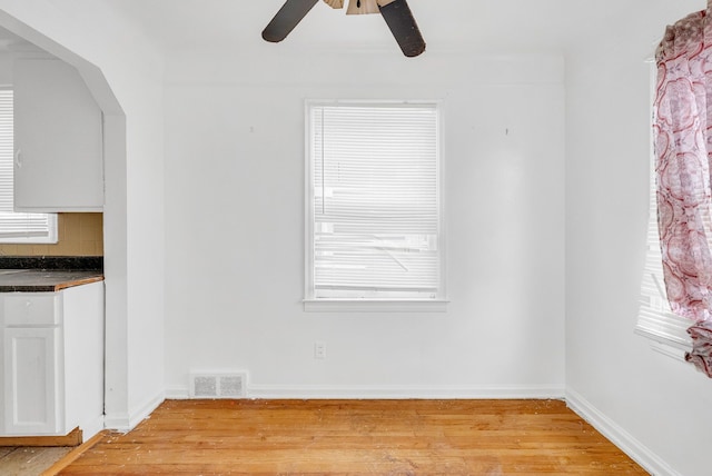 unfurnished dining area with ceiling fan and light hardwood / wood-style floors